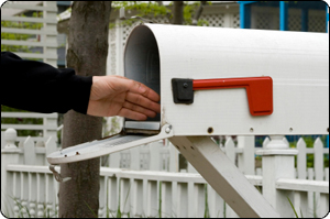 Hand reaching into mailbox for marketing materials